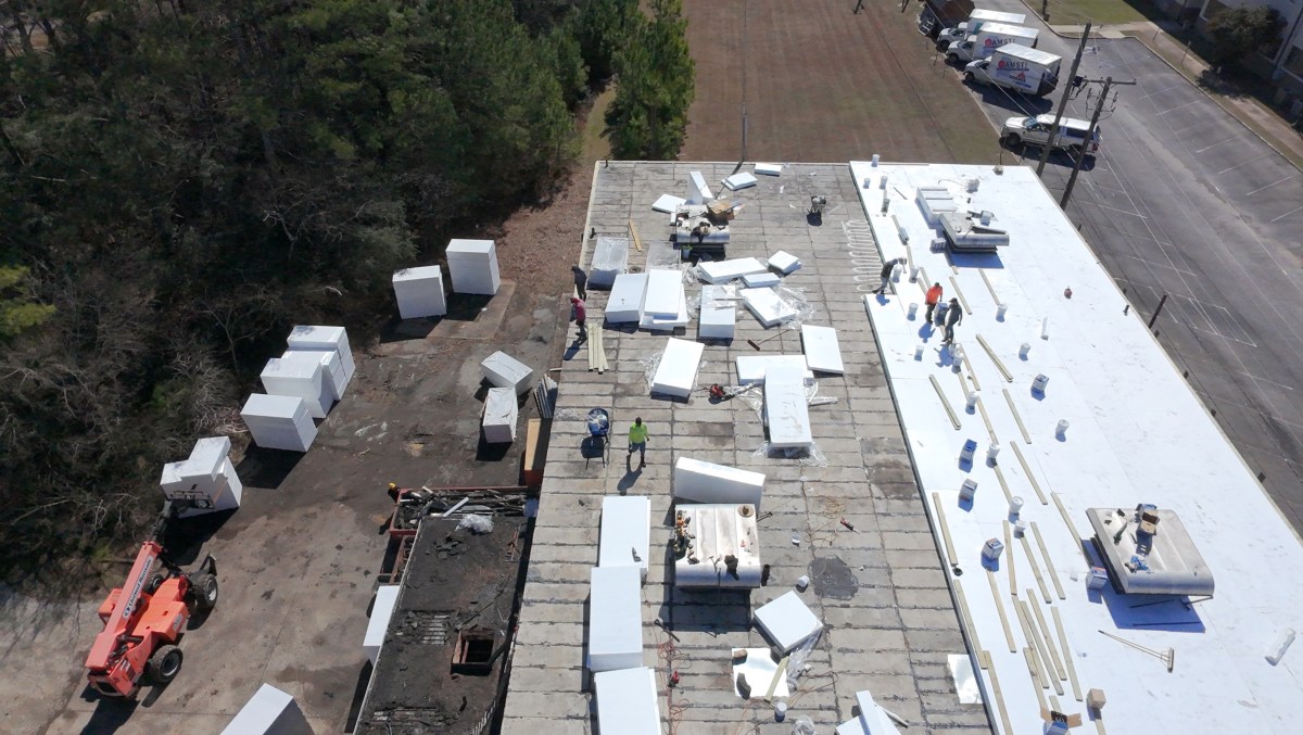 First Class Roofing commercial crew completing a flat roof retrofit