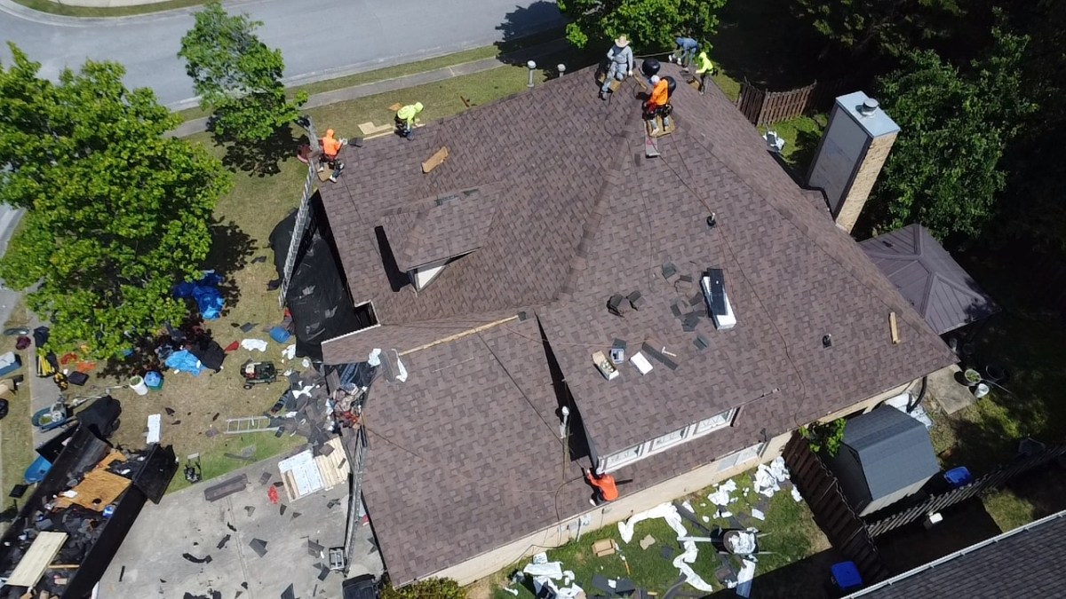 First Class Roofing crew installing a new residential shingle roof